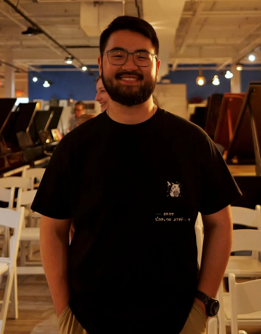 Smiling adult student standing in the Frank & Camille's gallery